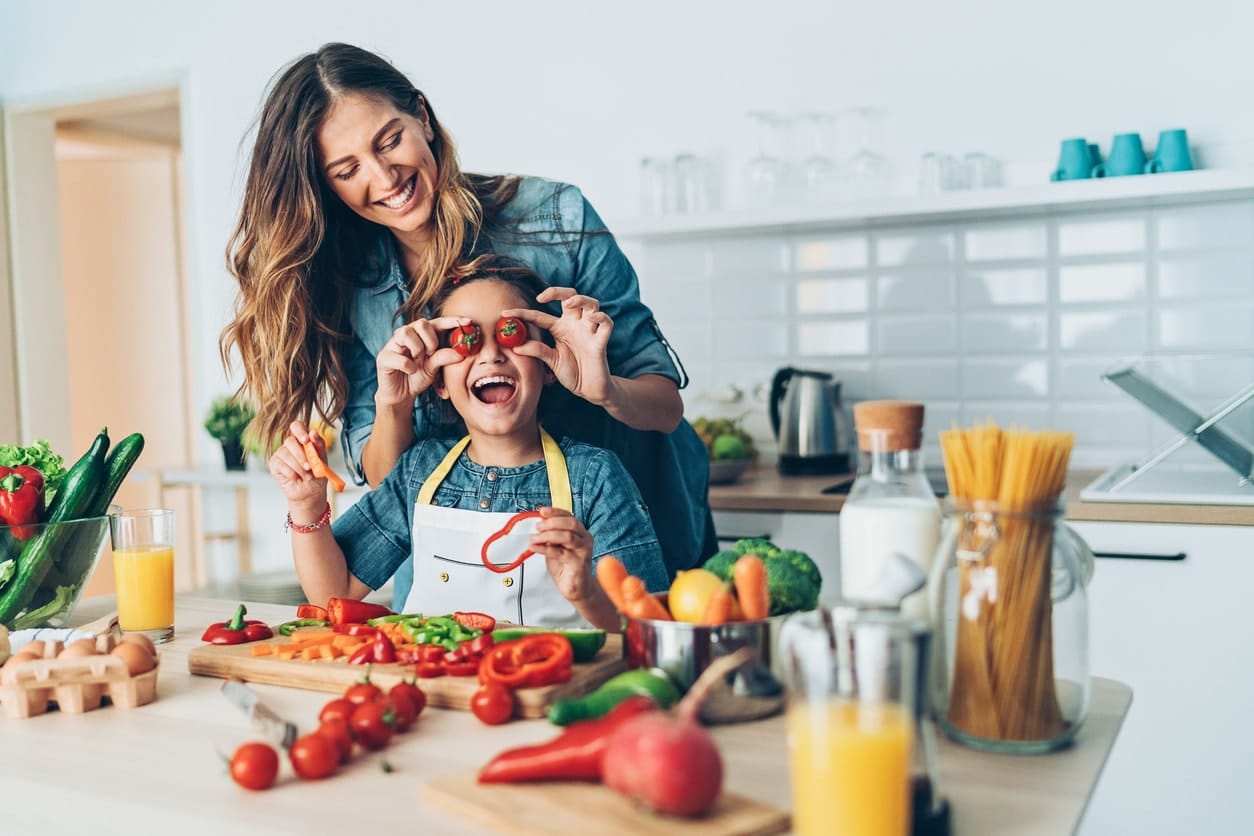 Senior couple having fun in kitchen cooking healthy food together